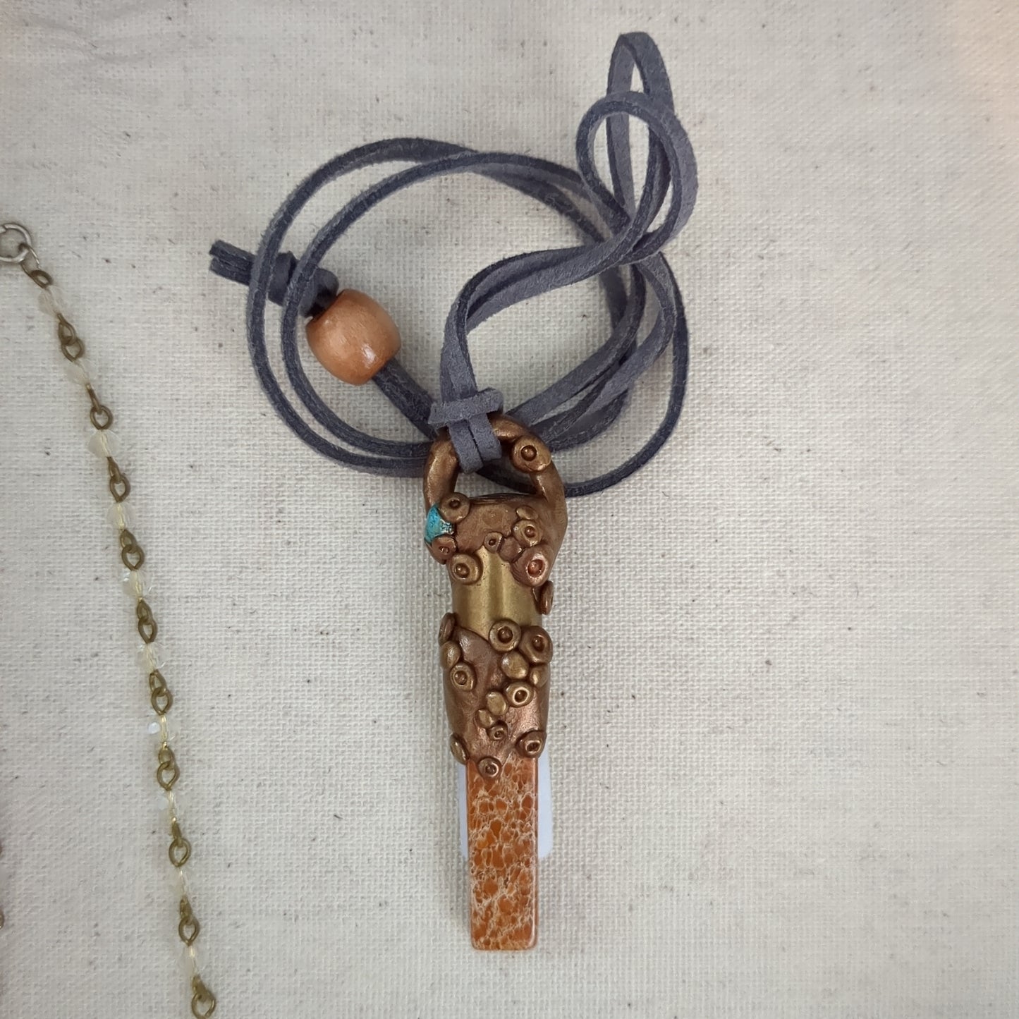 Bronze copper bullet pendant with rhyolite and turquoise suede cord