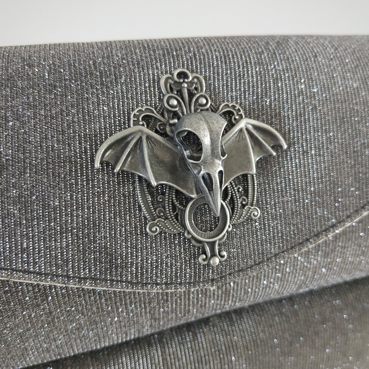 Silver clutch with raven skull and aura quartz zipper